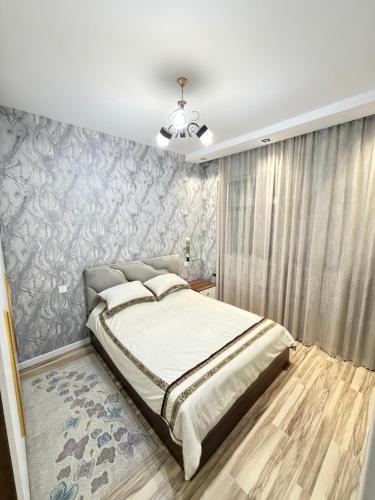 a bedroom with a bed and a wall mural at White Dream Villa in Mərdəkan
