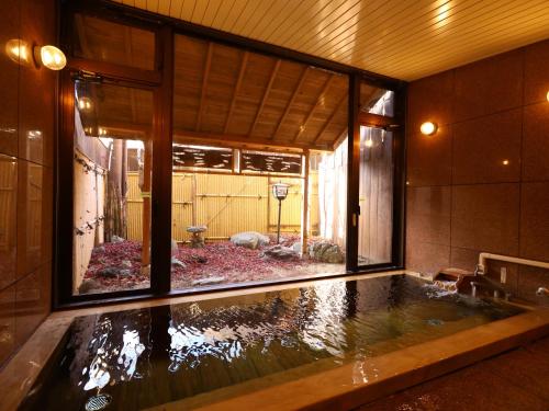 a large pool of water in a room with a window at Shoji Mount Hotel in Fujikawaguchiko