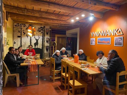 a group of people sitting at a table in a restaurant at Yanamanka in Yanama