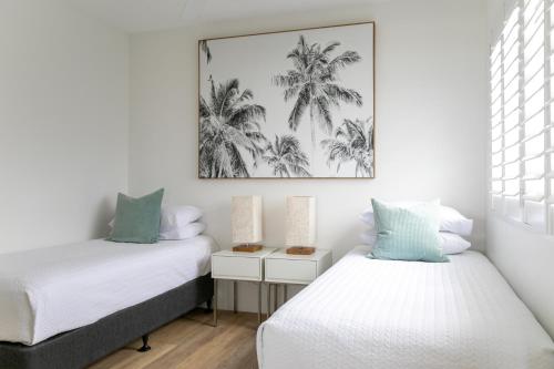 a bedroom with two beds and a picture on the wall at Noosa Crest Resort in Noosa Heads
