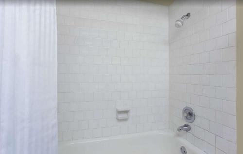 a white bathroom with a tub and a shower at FairBridge Inn Express Bellingham in Bellingham
