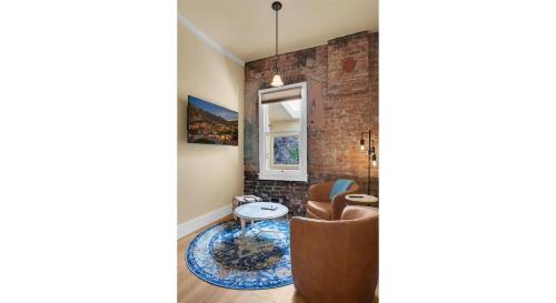 a living room with a brick wall at Letson Loft Hotel in Bisbee