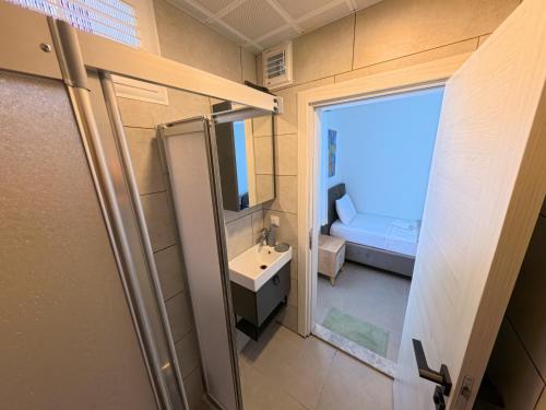 a small bathroom with a sink and a mirror at Merhaba Pansiyon in Bodrum City