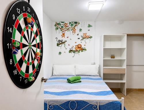 a bedroom with a dart board on the wall at Brisa del Mar - 2 min playa in El Ejido
