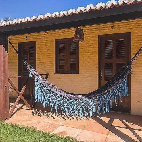 a hammock in front of a house at Eco Hostal Yuaiurú in Trairi