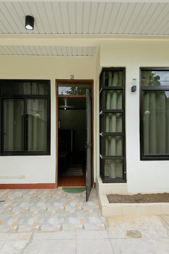an entry to a house with a glass door at Audi's Serviced Apartment in Puerto Princesa City