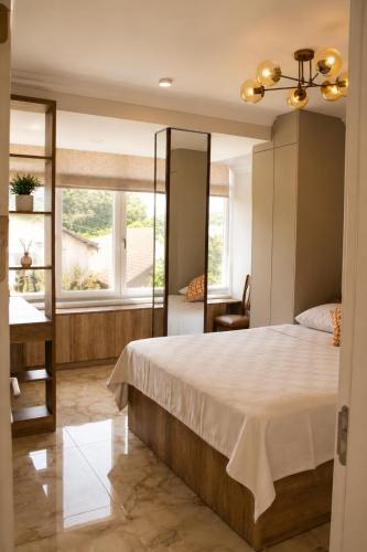 a bedroom with a large bed and a window at Villa Jasmine in Kartepe