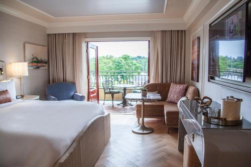 a hotel room with a bed and a balcony at Delamar Greenwich Harbor in Greenwich
