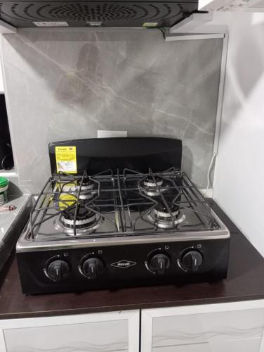 a stove top oven sitting on top of a kitchen counter at Hospedaje La Tebaida in La Tebaida