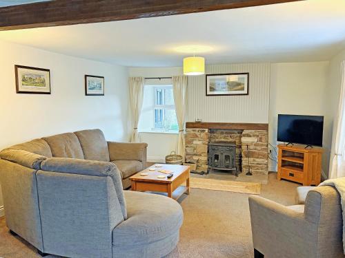a living room with two couches and a fireplace at High Park House in Brough