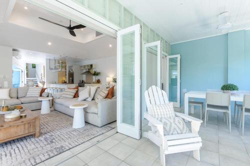 a living room with a couch and a dining room at Villa 8 on Murphy Prime Location & Lifestyle in Port Douglas