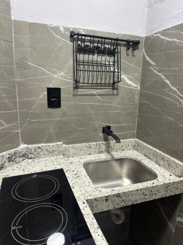 a kitchen with a sink and a counter top at D Castro Art House in Montes Claros
