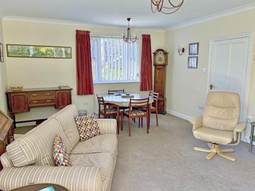 a living room with a couch and a table at Belgravia Cottage in Skipton
