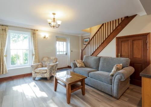 a living room with a couch and a table at Green Acres Cottages in Par