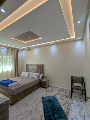 a bedroom with a bed and a chair in it at House apartment in Tangier