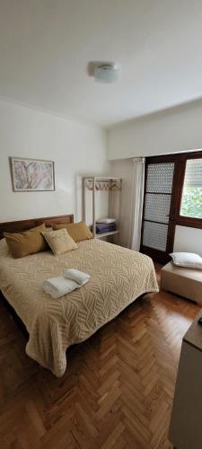 a bedroom with a large bed with two pillows on it at Departamento luminoso con balcón in La Plata