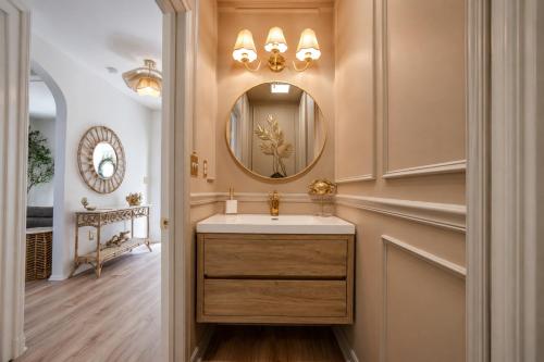 a bathroom with a sink and a mirror at Coastal Chateau Cottages in Ocean City