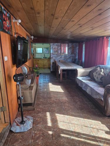 a living room with a couch and a table at Cabaña Tongariki in Hanga Roa