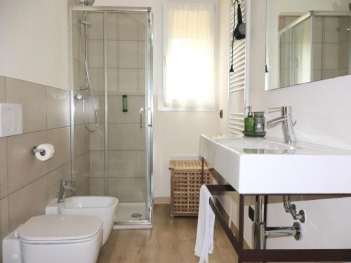 a bathroom with a sink and a toilet and a shower at In einer klimatisierten Wohnung mit Terrasse in Marone