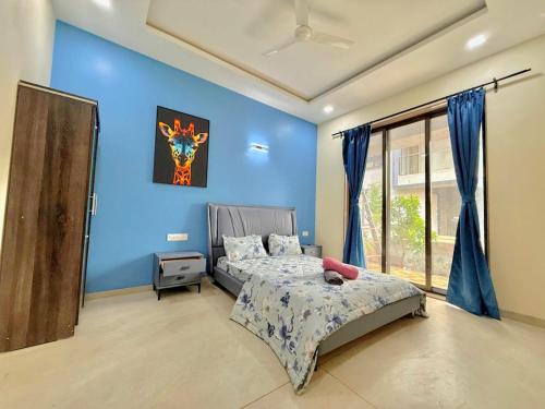 a bedroom with blue walls and a bed in it at Sunset havan villa in Lonavala
