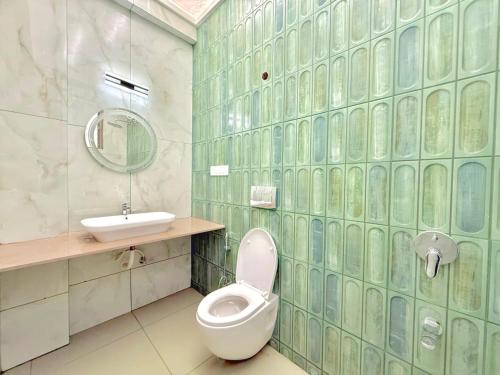 a bathroom with a toilet and a sink at Sunset havan villa in Lonavala