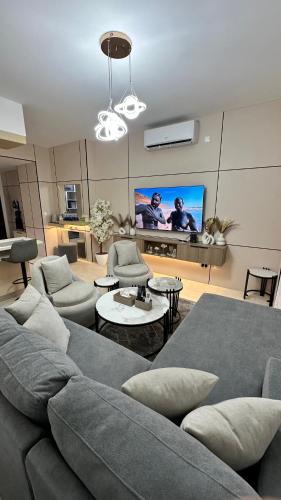 a living room with a couch and a flat screen tv at Raha Inn Apartment in Aqaba