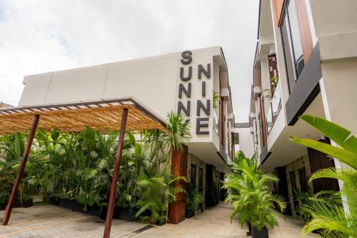 a building with a sign on the side of it at Sunny Aparts 1 by Betterplace in Canggu