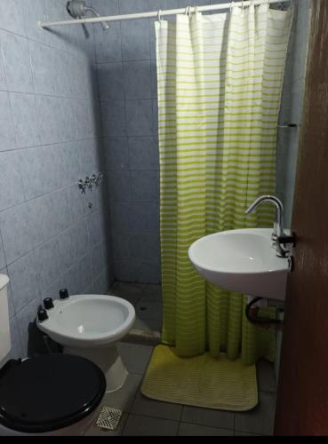 a bathroom with a sink and a toilet and a shower at Linda estadia 2 in San Juan