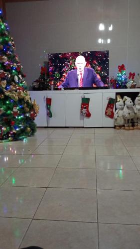 a tv screen in a room with a christmas tree at Jakcqueline in Pucallpa