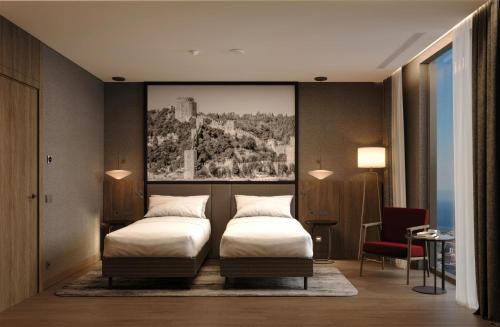 a bedroom with two beds and a painting on the wall at Radisson Blu Residences, Istanbul Kartal in Istanbul