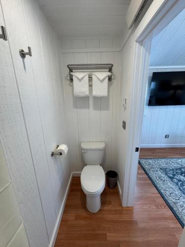 a small bathroom with a toilet and towels at Tiny Yellowstone Riverside Cabin in Gardiner