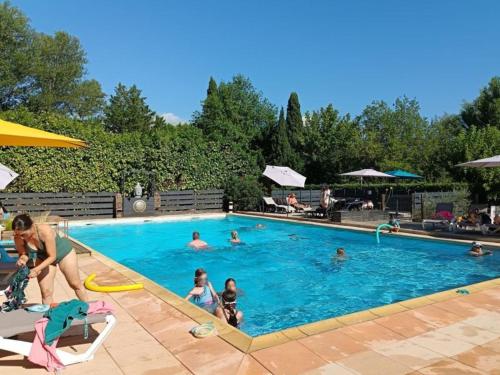 a group of people in a swimming pool at Chalet clim, TV - 2 pers. - API-1-52-2795 in Noves