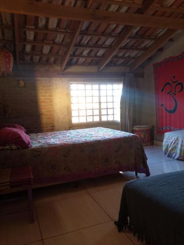 a bedroom with two beds and a window at Espaço Além da Lenda in Alexânia