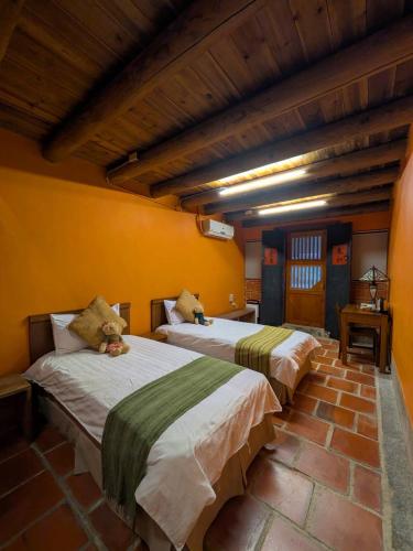 a bedroom with two beds with teddy bears on them at PianoPiano B&B in Jincheng