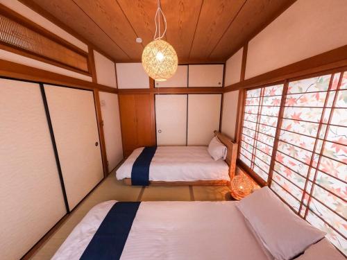 two beds in a room with two windows at 3 min from the station in Tokyo