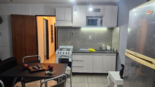a small kitchen with a table and a stove at Nova in Mendoza