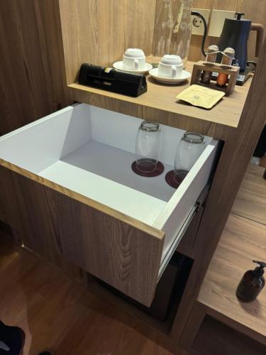 a sink in a counter with two glasses on it at Kaiarasa Villas and Suite in Canggu