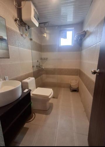 a bathroom with a toilet and a sink at krishna kunj stay in Mathura