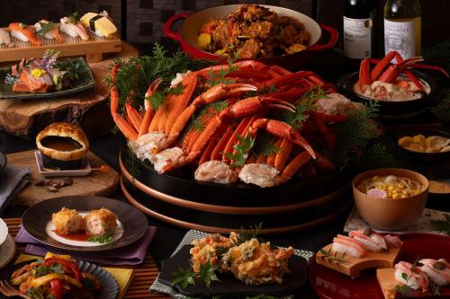a table with many plates of food on a table at Ooedo Onsen Monogatari Premium Yamashitaya in Kaga