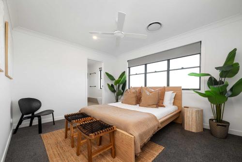 a bedroom with a bed and a chair and a window at Stylish Clontarf Townhouse & Parking in Clontarf