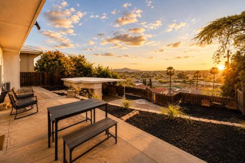 a patio with two benches and a table with a view at 2Homes Villa Renovated Views in La Mesa