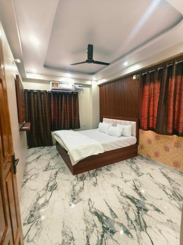 a bedroom with a bed with a marble floor at Hotel Blue Neck in Patna