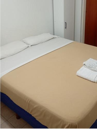 a large white bed in a white room at Hotel Cielo Cuyano in San Juan