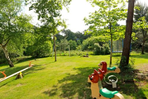 a park with a playground with a toy horse at Chambres du Bout du Monde in Landévennec