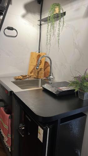 a kitchen with a counter with a sink and a sink at A corner by the sea in Ashdod