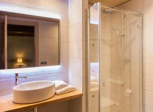 a bathroom with a sink and a shower at La Masoveria de Mateus in Sagás