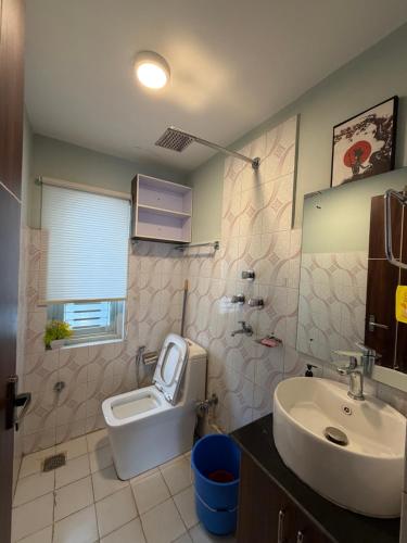 a bathroom with a toilet and a sink at Sierra Service Apartment in Pātan