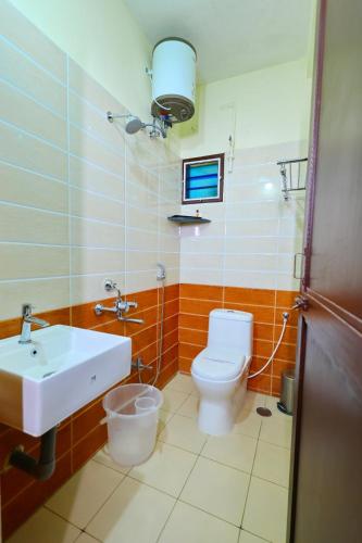 a bathroom with a toilet and a sink at Hotel Shree Laksha Residency Madurai in Madurai