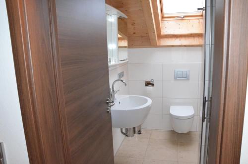 a bathroom with a sink and a toilet at Ferienwohnung Emmert Landshut in Landshut