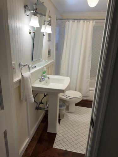 a white bathroom with a sink and a toilet at Near the Slopes - Big Bear Mountain getaway in Big Bear Lake